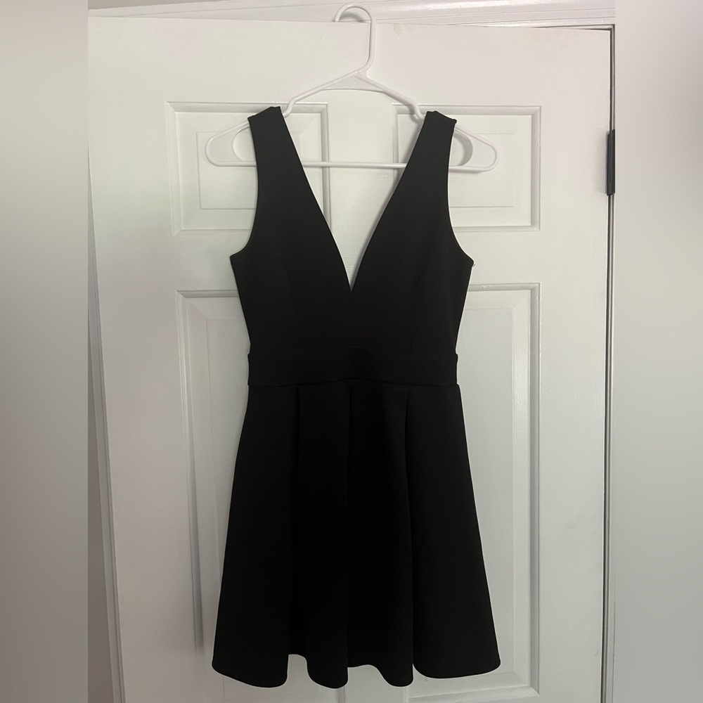 Alythea black skater dress. Sleeveless with plunging neckline.